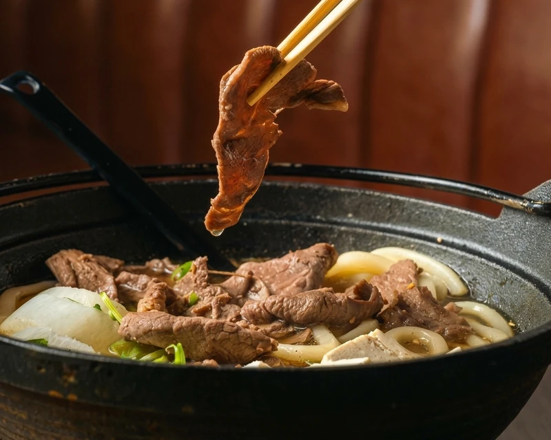 Bowl of Beef Udon noodle soup with sliced beef and scallion at Kon'ya Japan, Mount Pleasant, Calgary